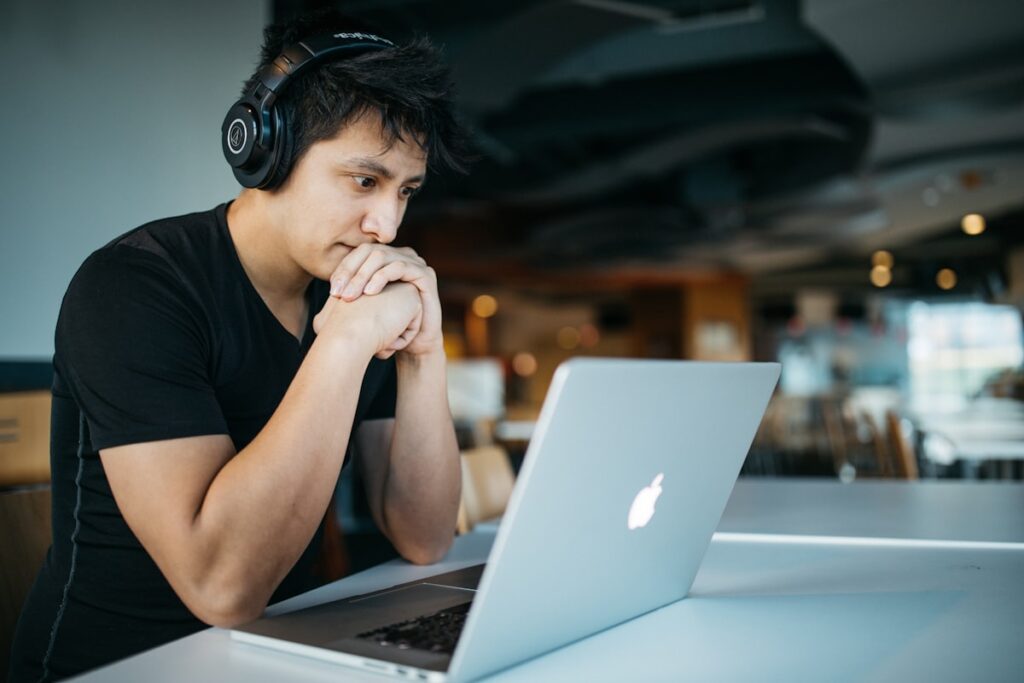 Student studying online with a laptop and headphones