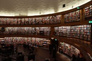 Students reading and studying in a large university library