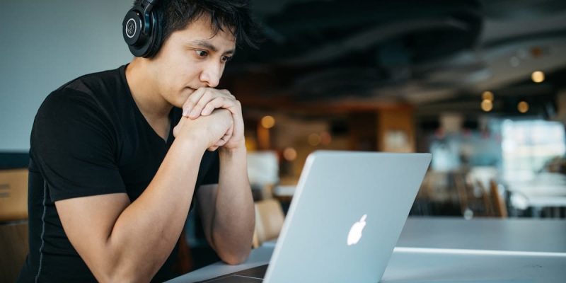 Student studying online with a laptop and headphones